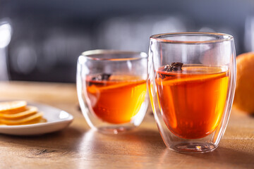 Winter drinks Hot Aperol Spritz two glass cups on a bar counter