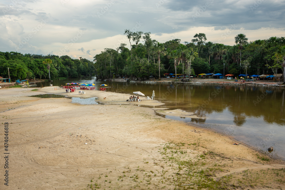 Wall mural Beautiful view of beach on Urubu River, forest trees on cloudy summer day before rain in Amazon Rainforest. Manaus, Amazonas, Brazil. Concept of environment, ecology, nature, conservation, travel.