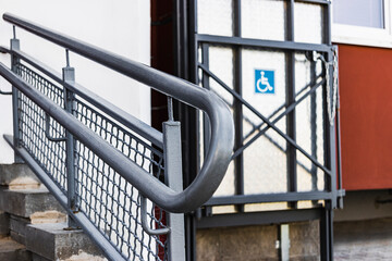 Wheelchair ramp with lift at the entrance to a residential apartment building.