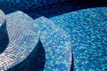 Industrial engineering. Professional tiling in the pool. Installation of blue ceramic pool tiles on...