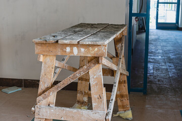 Wooden construction scaffolding for construction work at a height inside the building. Indoor finishing platform.