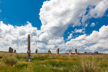 Totem pole tied with ritual ribbons. Salbyk mound in the steppe of Khakassia. Archaeological...