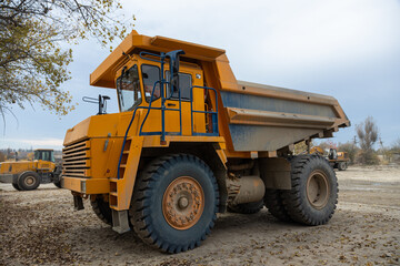 Fototapeta na wymiar Large mining dump truck. Transport industry. Extraction of stone in an open pit