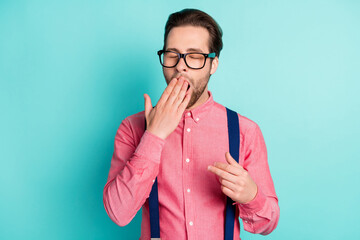 Photo of young bored exhausted man yawn sleepy cover hand mouth face isolated on teal color background