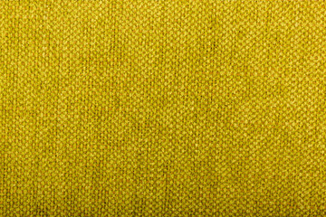 Factory fabric with brown and yellow threads interspersed. Close-up long and wide texture of natural fabric. Fabric texture of natural cotton or linen textile material