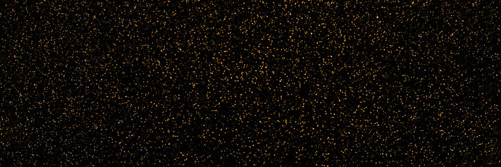 Black and golden sparkling glitter bokeh background, christmas shiny texture. Holiday lights. Abstract defocused header. Wide screen wallpaper. Panoramic web banner with copy space for design