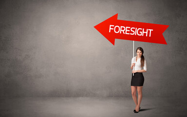 Obraz premium Young business person in casual holding road sign