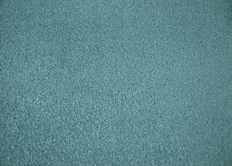 Green indoor office carpet texture. High resolution seamless monochrome wool fabric background. Interior material background top view. Short pile carpet. Blank generic microfiber textile texture.