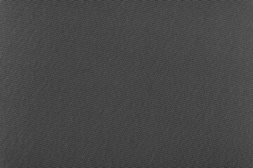 Background made of gray material. Fabric for sewing clothes in a dark shade. Texture