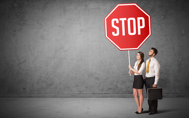 Young business person holding road sign