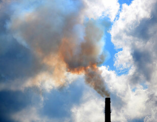 pipe with thick smoke and the sky on contrasting background of clouds, filter