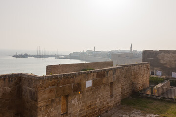 Fototapeta na wymiar The fortified wall of the Akko fortress with a turret