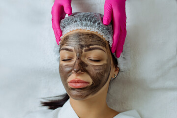 Close-up of carbon peeling procedure for middle-aged woman face. Laser pulses clean skin. Process...