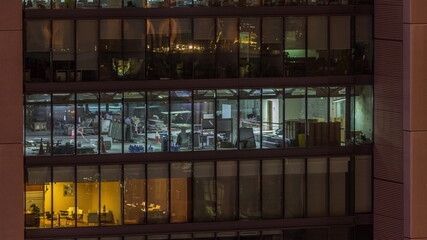 Big glowing windows in modern office buildings timelapse at night