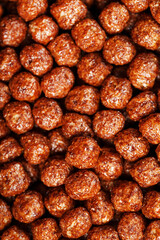 Ready breakfast chocolate balls texture close-up, background