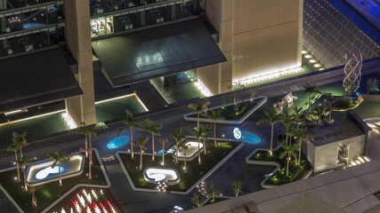 New promenade on gate avenue located in Dubai international financial center aerial night timelapse.