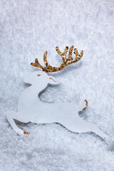 Christmas composition. Snow  with a deer in the middle. White decorations. Winter, new year concept. 