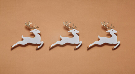 Christmas composition with white wood deer on color paper background.  Winter, new year concept.