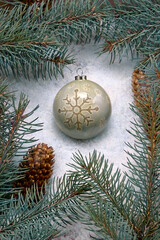 Christmas decoration over snow with fir-tree background.Top view