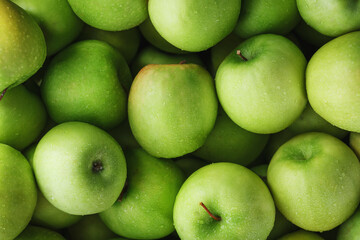 Juicy Green apple close-up with dew drops.