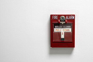 Fire alarm box on a white wall with copu space
