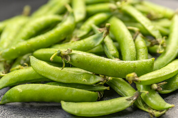 Close up photo green pods of fresh just ripped off peas. Vegetable background. Legumes.