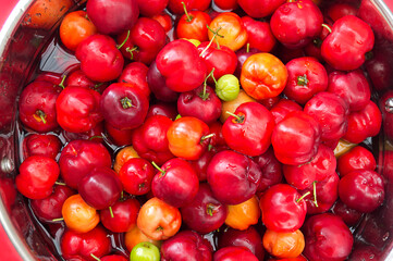 bucket of fresh acerola fruit