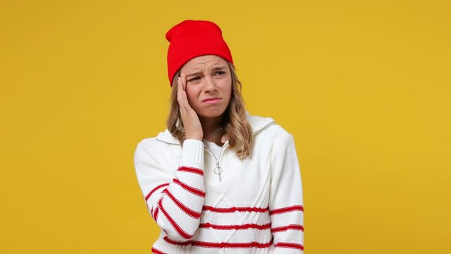 Tired young girl teen student wears striped white shirt hat did not get enough sleep last night after party and barely got up in the morning yawning isolated on plain yellow background studio portrait