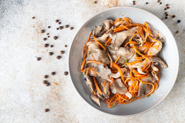 oyster mushrooms salad pickled mushrooms, carrots, Korean marinade healthy meal diet snack on the table copy space food background rustic. top view keto or paleo diet veggie vegan or vegetarian food