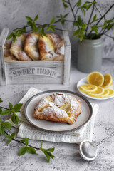 Obraz na płótnie Canvas puff pastry envelopes with cottage cheese and lemon zest, sprinkled with powdered sugar