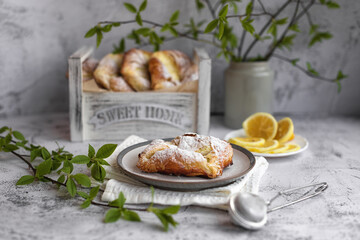 puff pastry envelopes with cottage cheese and lemon zest, sprinkled with powdered sugar