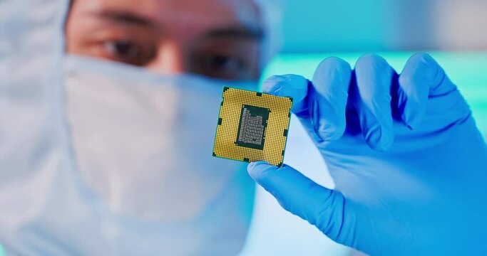 engineer holds microchip