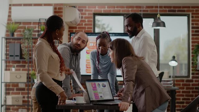 Business people doing teamwork for project planning in office, using files with statistics and laptop to design financial presentation. Colleagues working with data analysis for strategy.