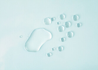 Transparent water drops. Light delicate blue tone background.