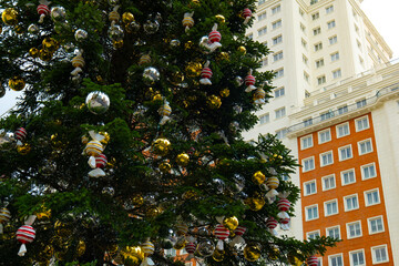 Christmas tree with a skyscraper in the background