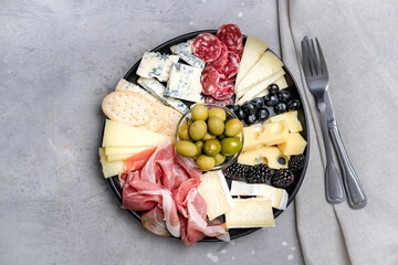 Charcuterie plate with prosciutto, salami, cheese and berries, olives. Aperitif Antipasti Italian...