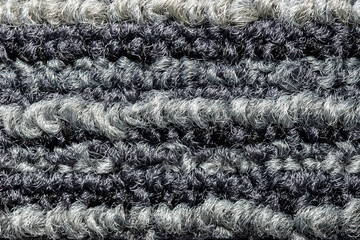 Fototapeta premium Seamless close up of monochrome grey carpet texture background from above..