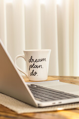 Motivational mug written dream, plan, do at home office