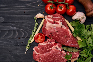 meat on wooden board vegetables and ingredients for cooking wooden background