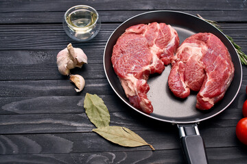 meat steak in a frying pan food ingredients kitchen wooden table