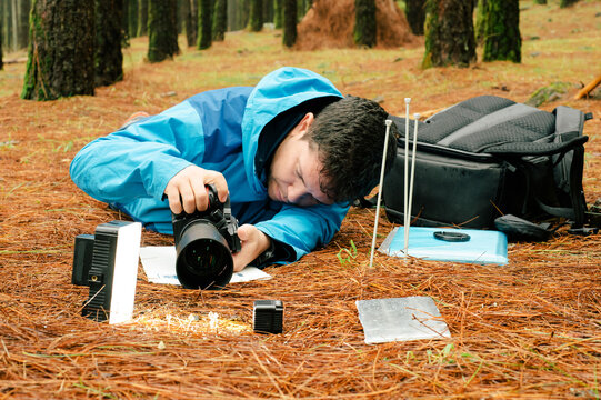 Photographer taking photo of toadstool mushrooms