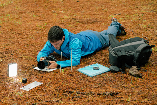 Photographer taking photo of toadstool mushrooms