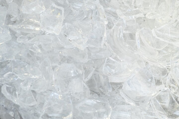 Large pile of waste glass smithereens prepared for recycling and different items making as background extreme upper close view