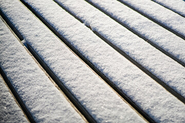 winter wooden veranda covered with a thin layer of snow fragment,  blurred image
