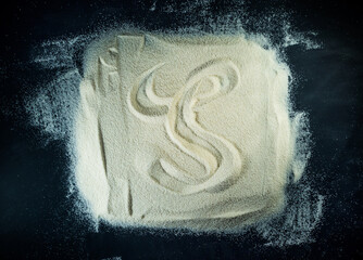 Greek letter zeta written on the white sand with black background