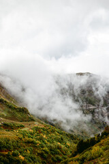 Peaks of Mount Aibga in autumn clouds