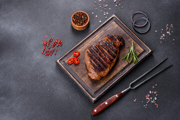 Cooked grilled Chuck eye roll steak on a chopping Board