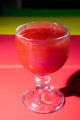 Glass full of watermelon juice on colorful table in Guatemala City, refreshing natural drink.