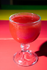 Glass full of watermelon juice on colorful table in Guatemala City, refreshing natural drink.