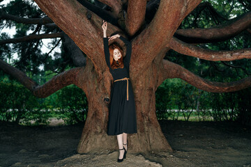 woman in black dress nature walk garden trees fresh air